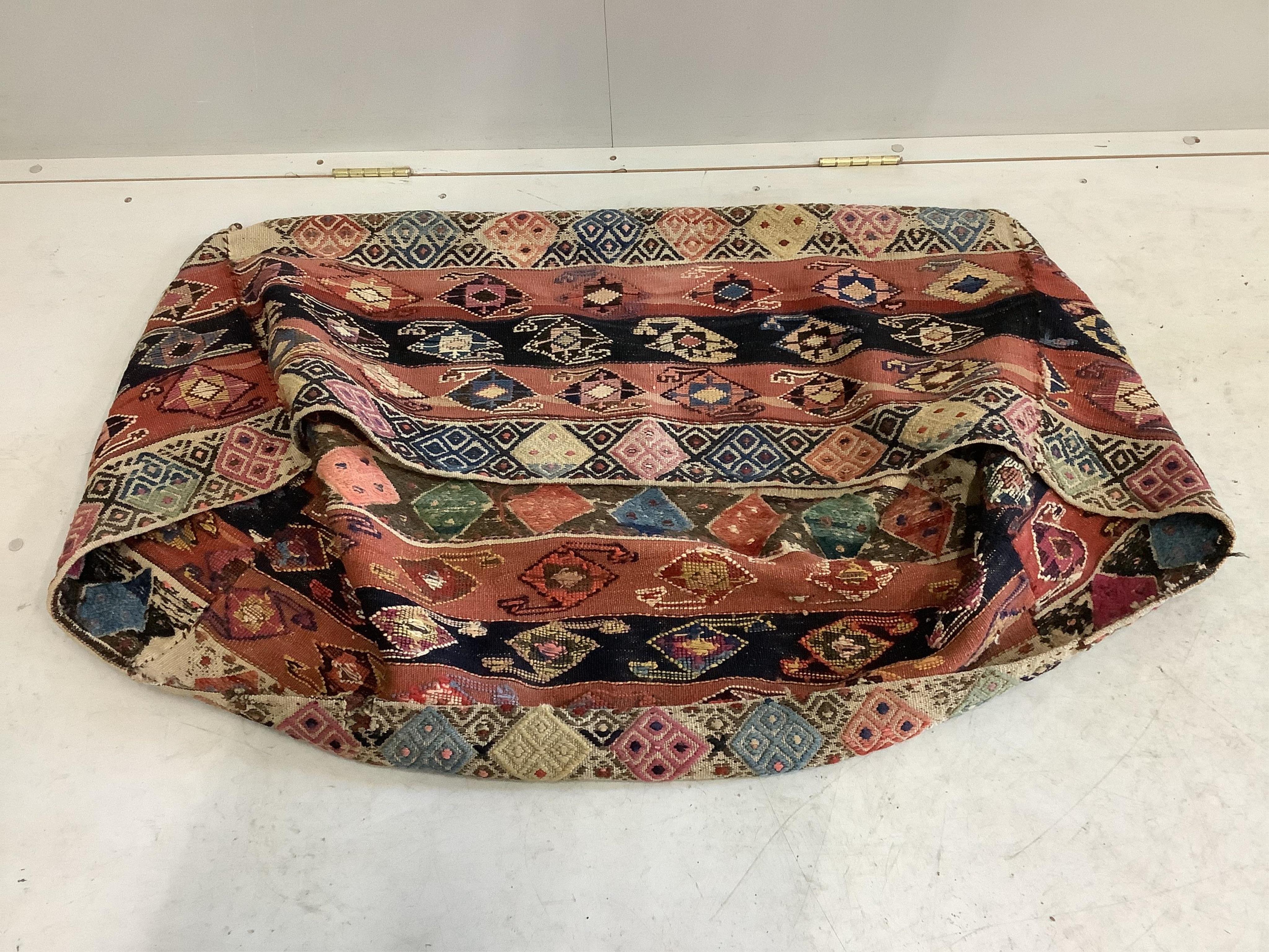 An antique Kilim polychrome cover, width 100cm, depth 40cm, height 45cm. Condition - fair